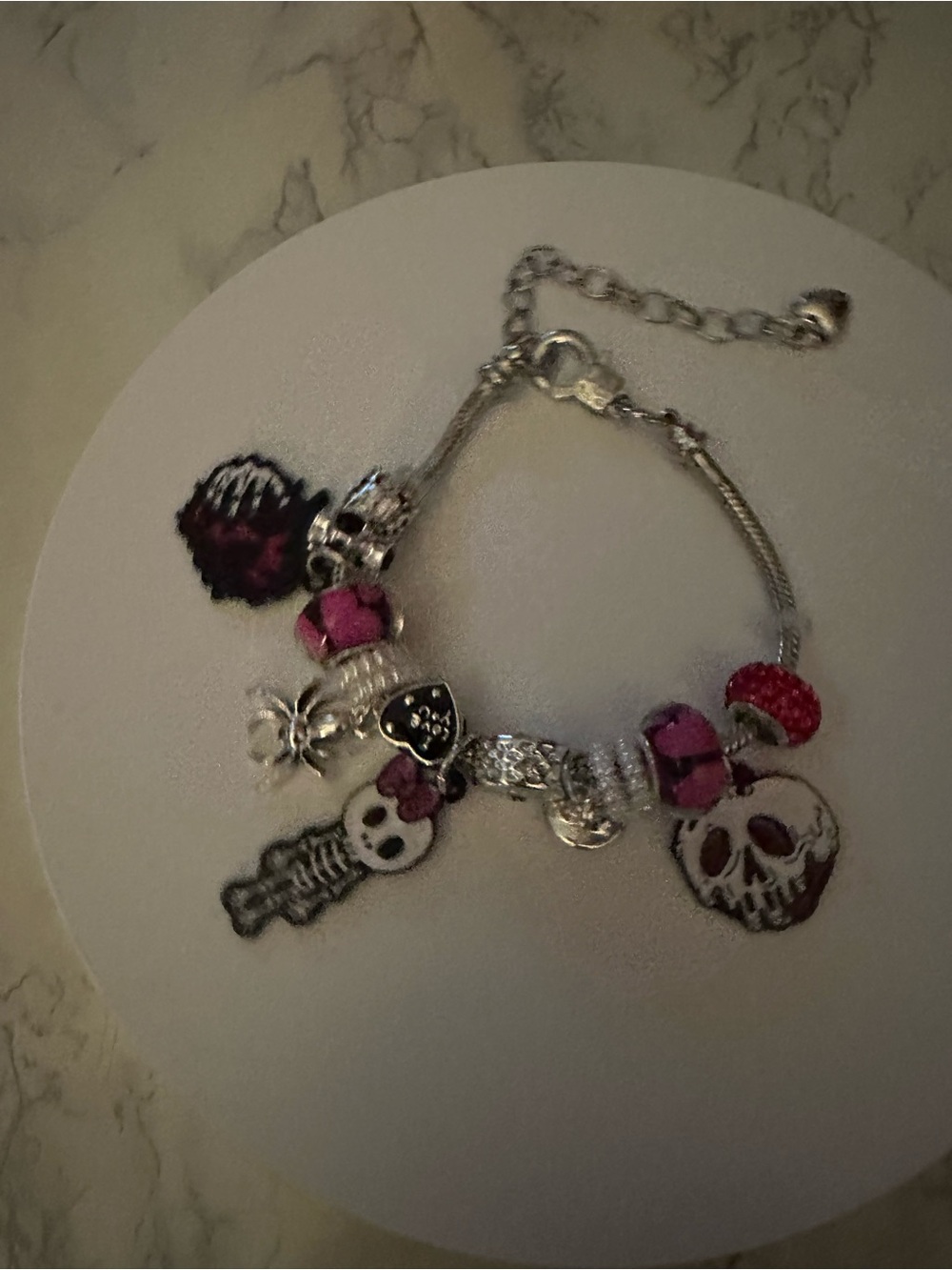 Silver Charm Bracelet with Pink Accents and Skull Motifs